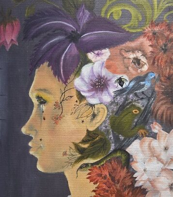 Profile of a woman with flowers and birds in her hair